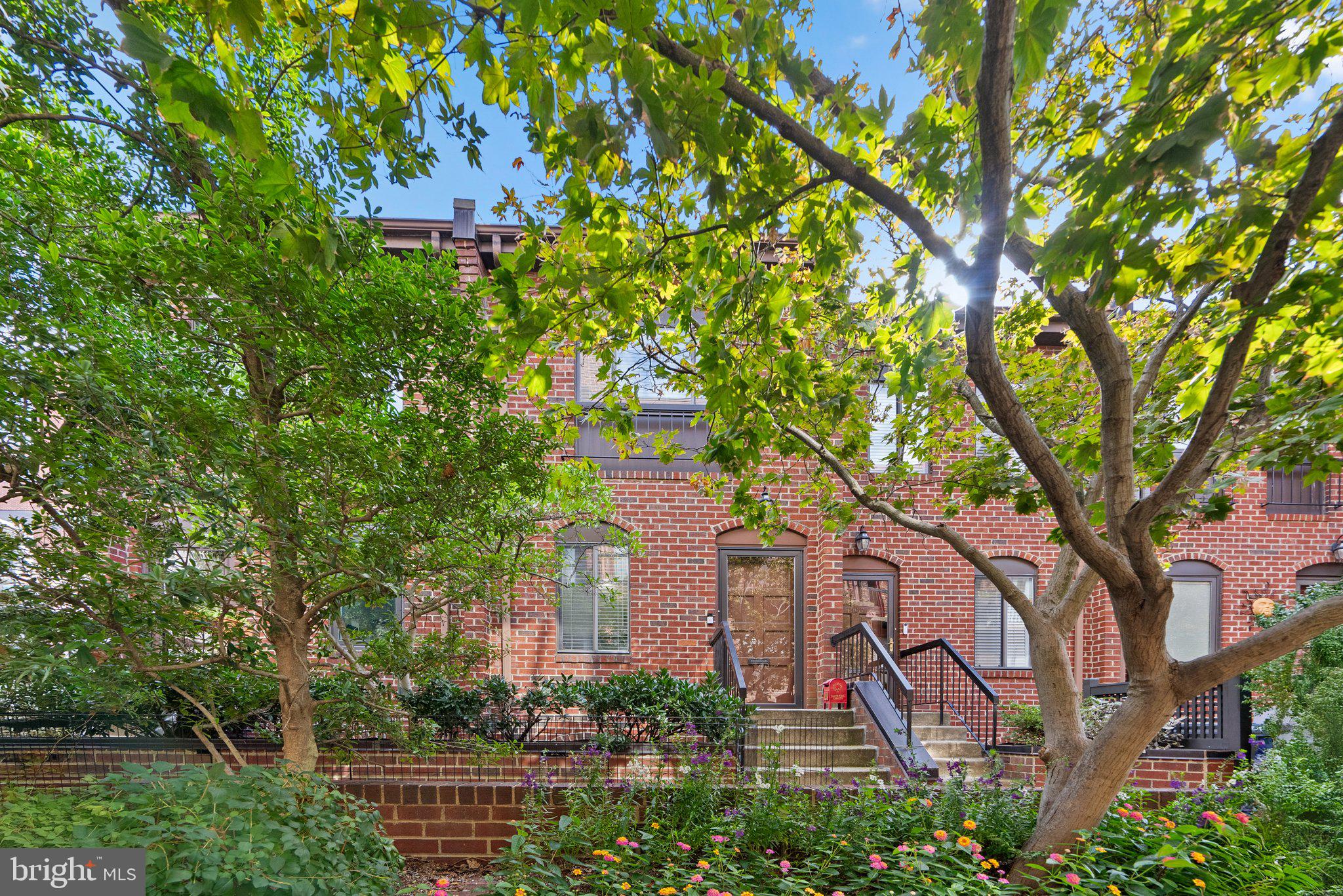 a front view of a house with a tree