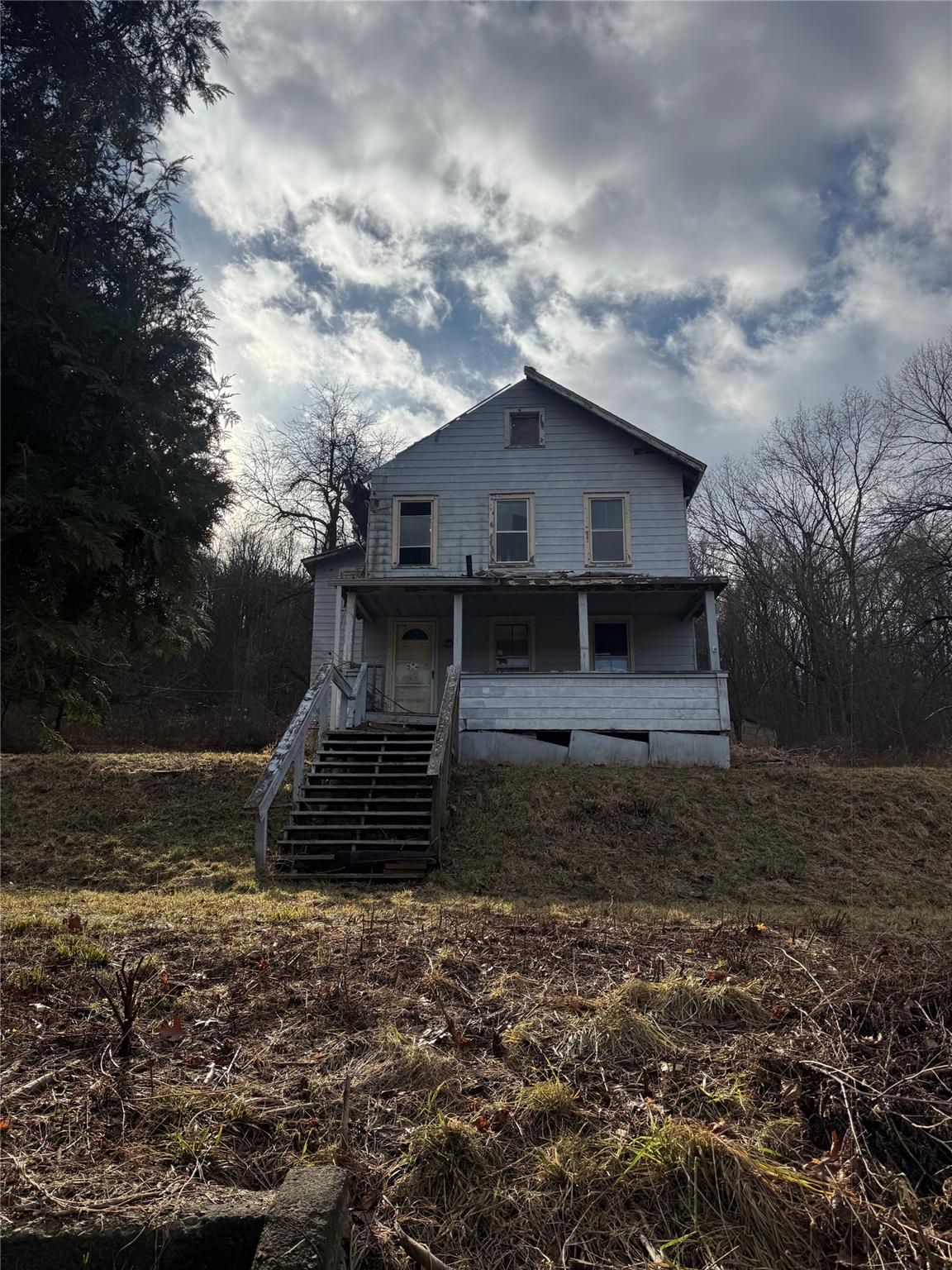 Back of house with covered porch