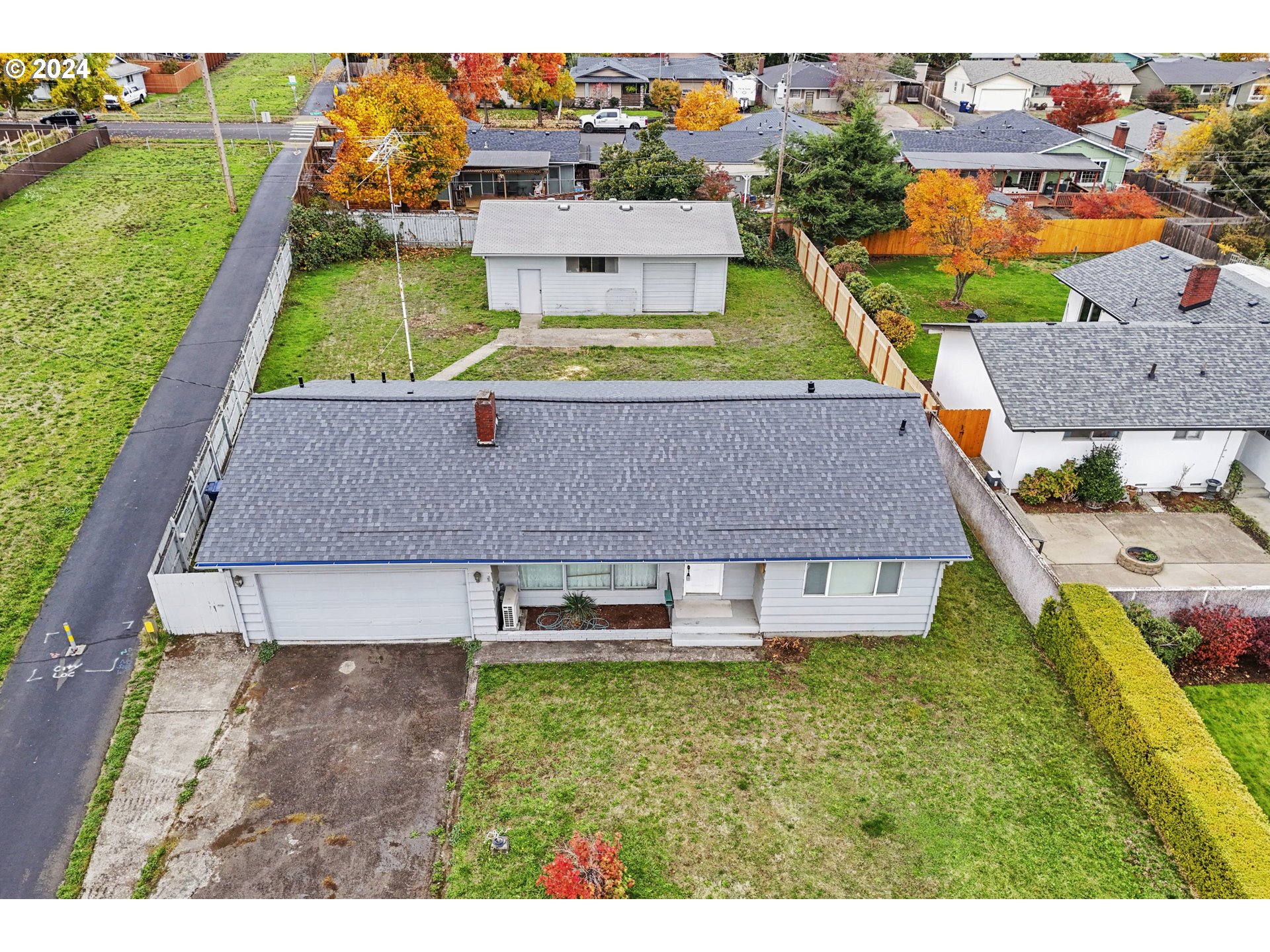 an aerial view of a house with a garden and swimming pool