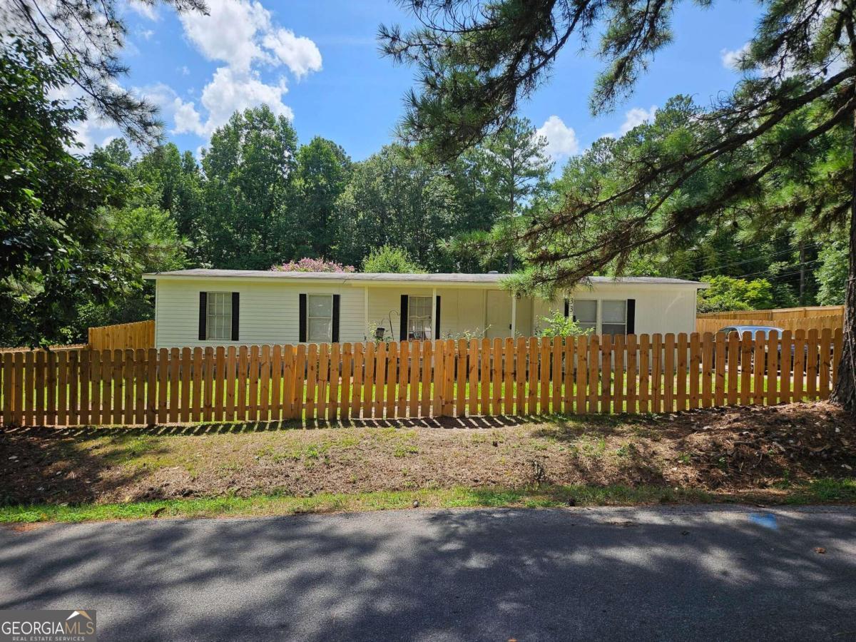 a front view of a house with a fence