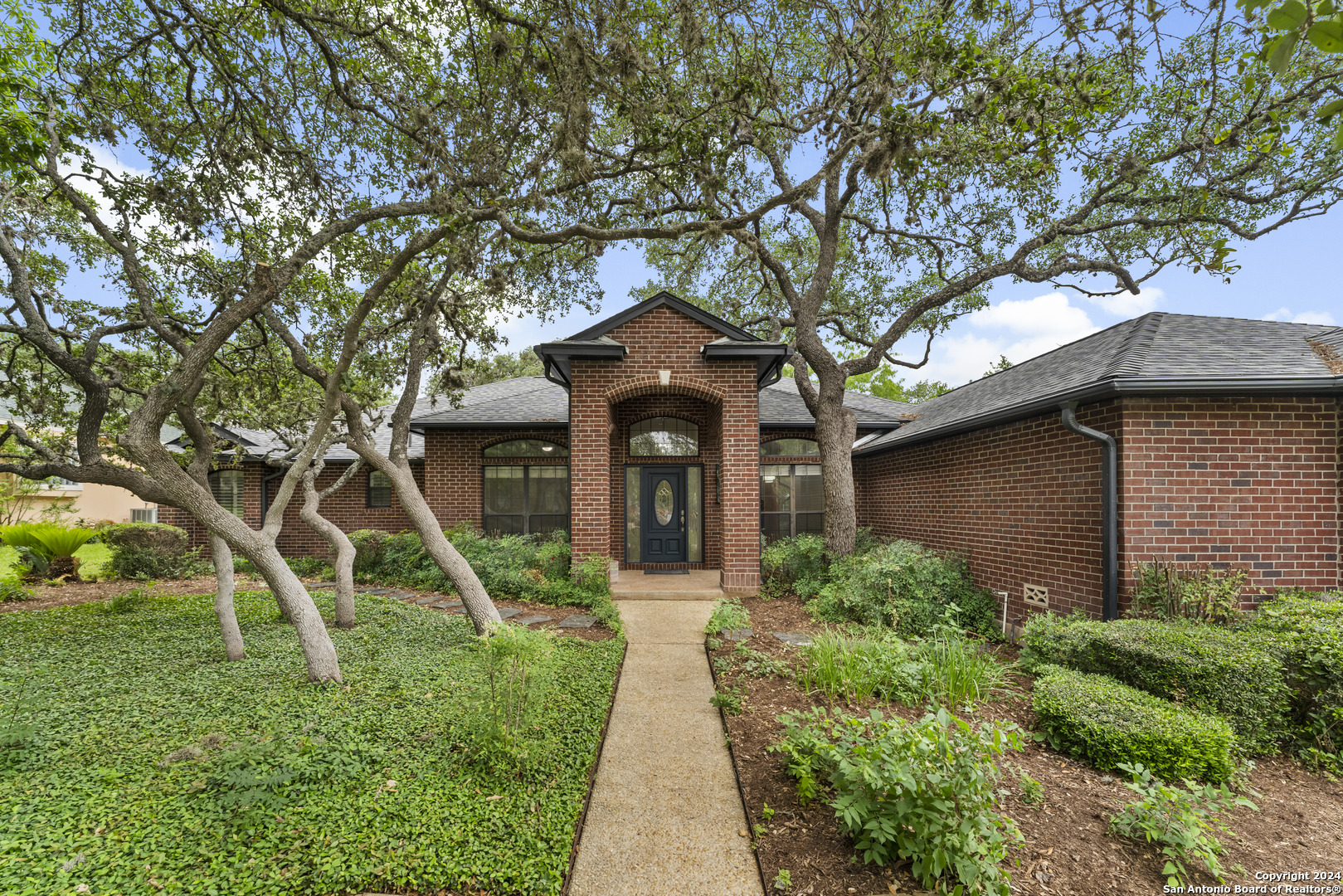 a front view of a house with garden