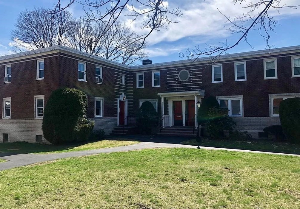 a view of a brick house with a yard