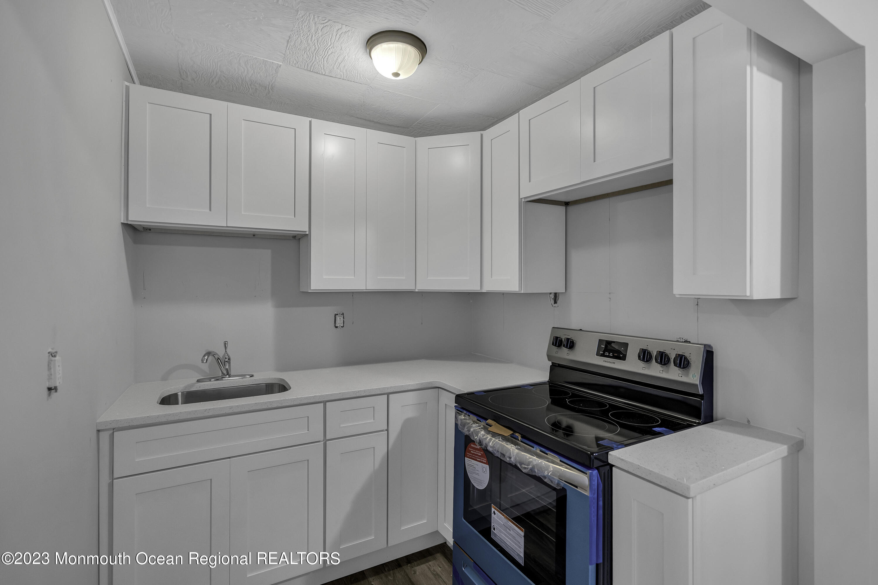 a kitchen with cabinets appliances and a sink