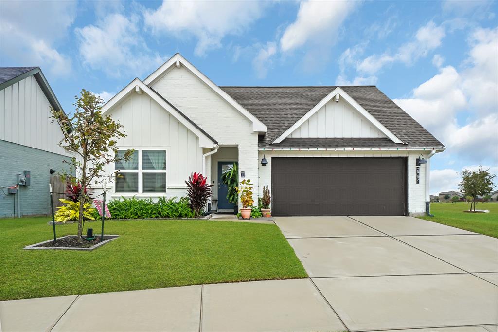 a front view of a house with a yard and garage