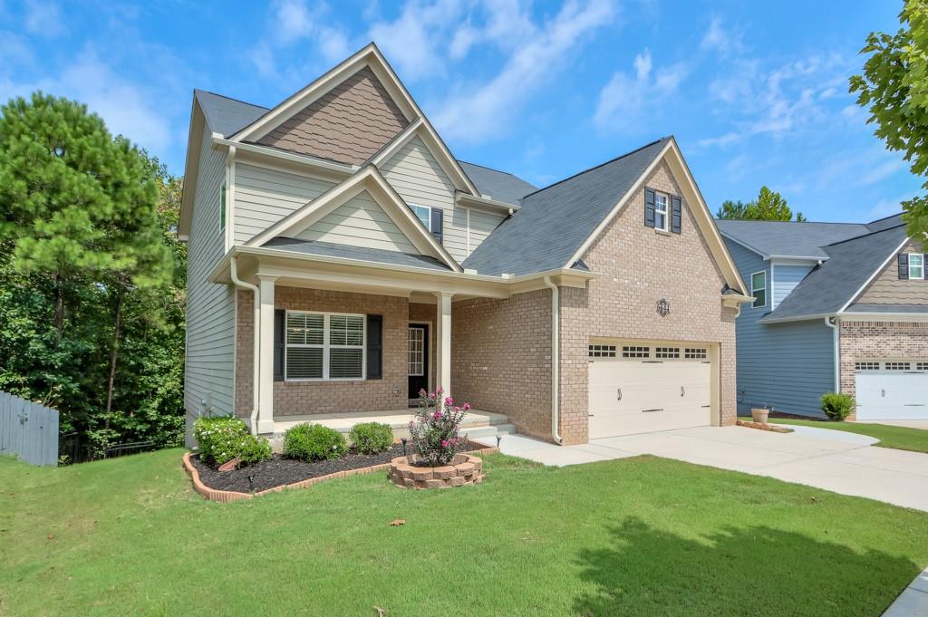 a front view of a house with a yard and garage