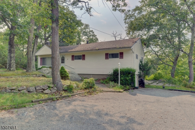 a view of a house with a yard and large tree