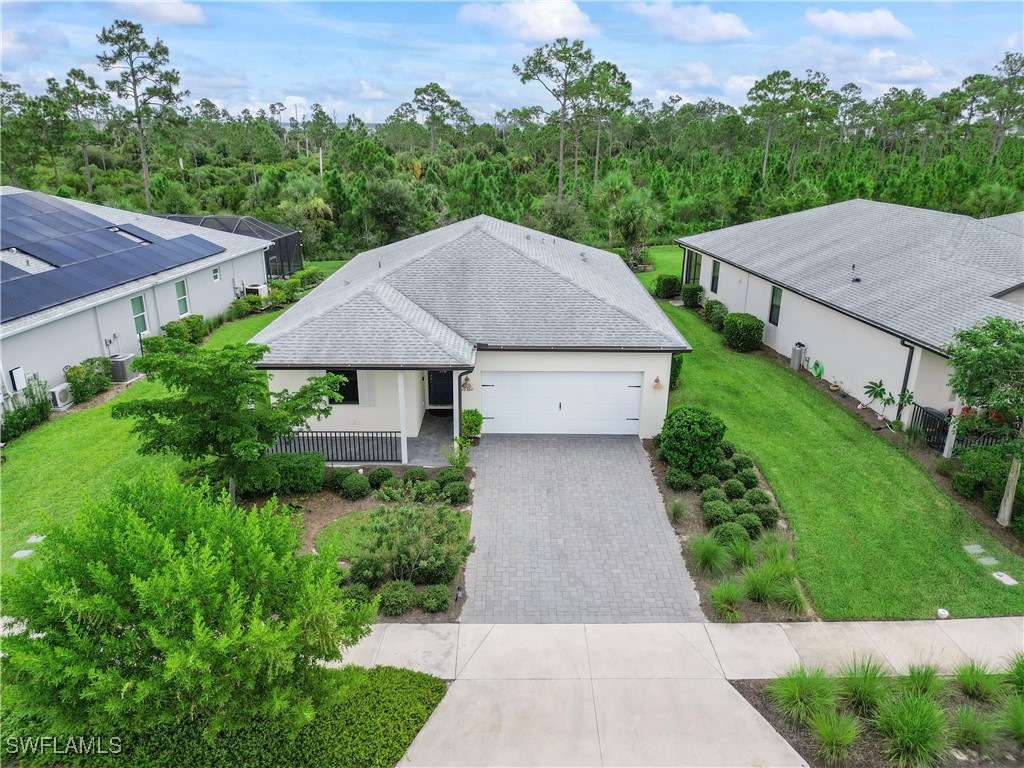 an aerial view of a house with a yard