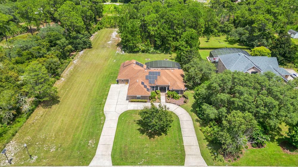 an aerial view of a house with a swimming pool