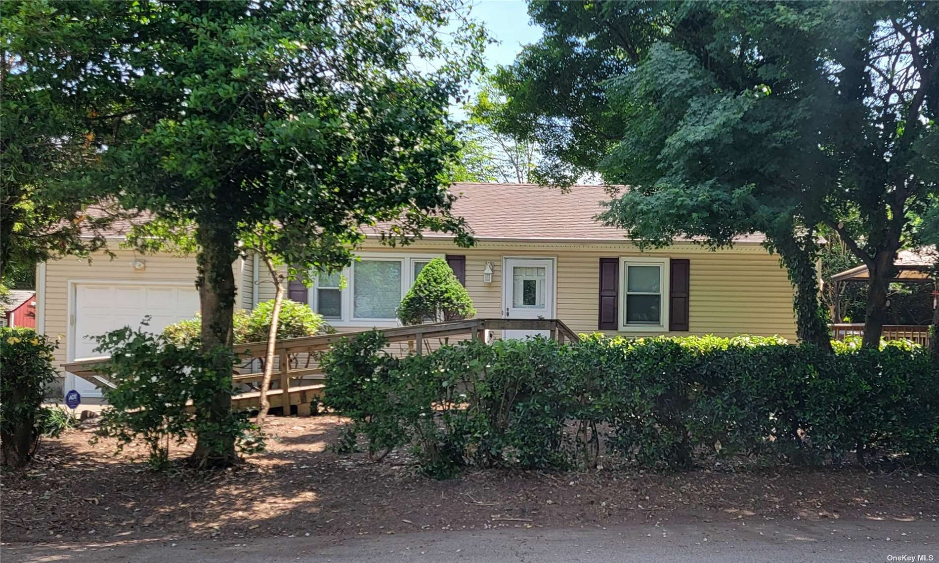 a front view of house with yard and green space