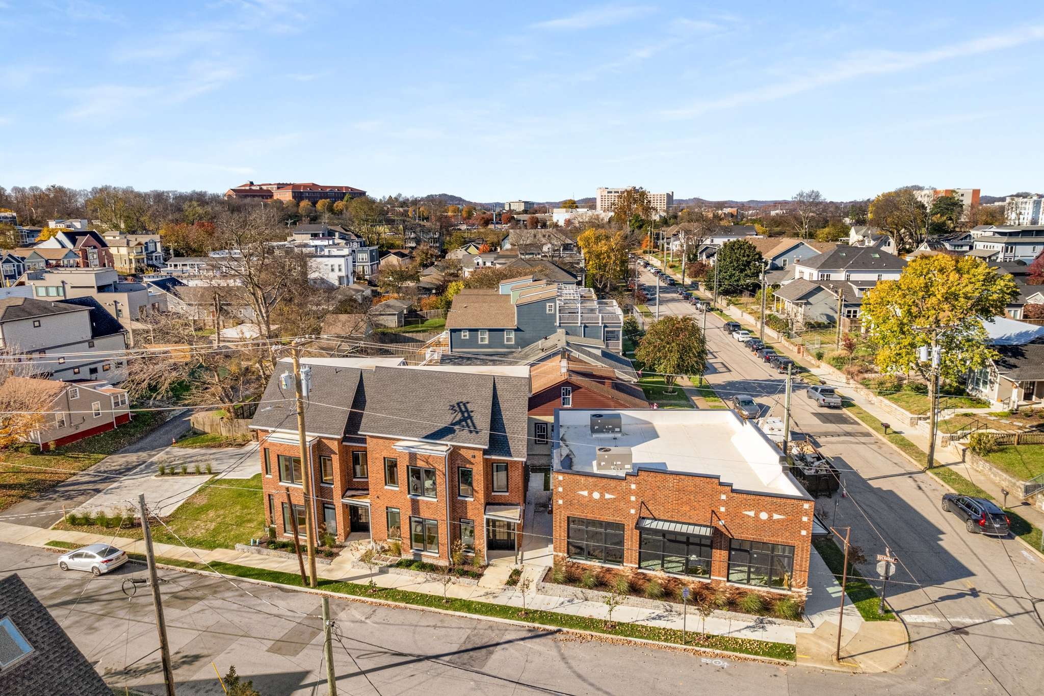 an aerial view of residential houses with city view