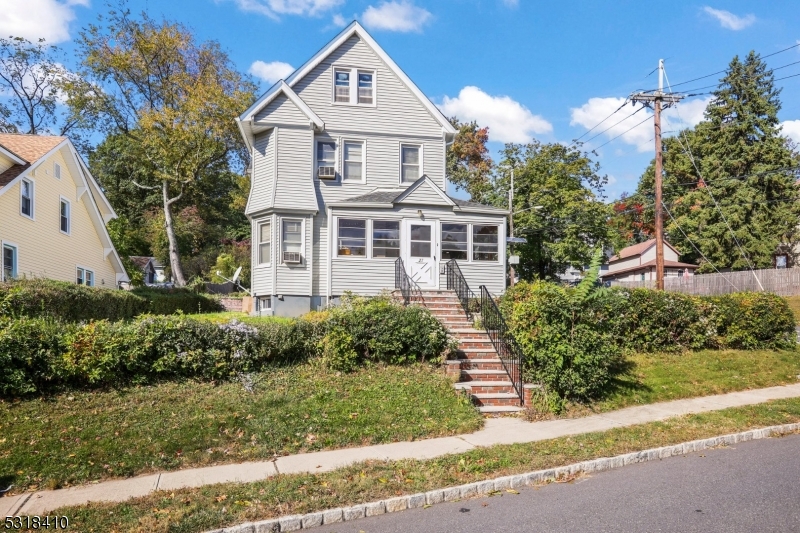 a front view of a house with a garden