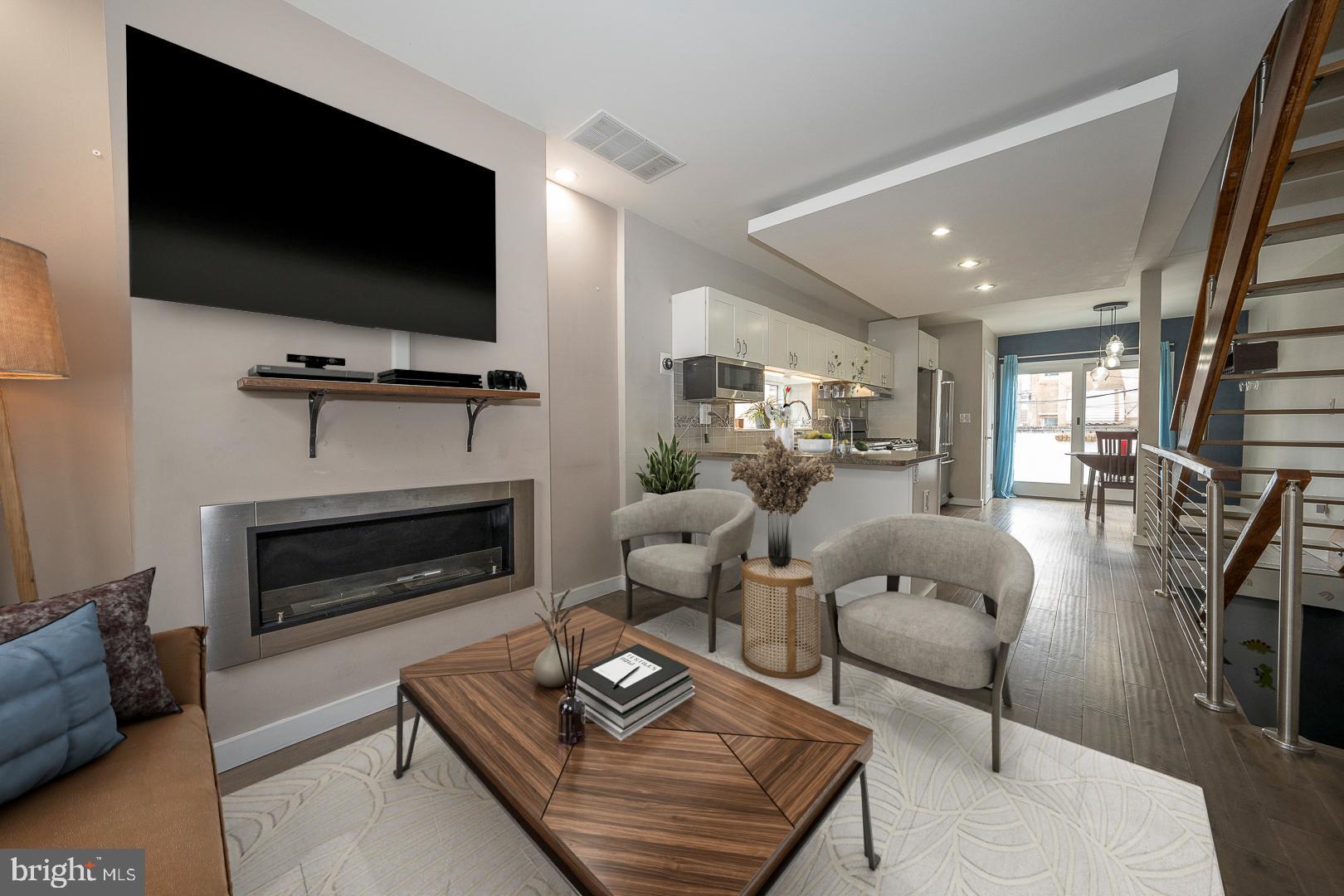 a living room with furniture a flat screen tv and a fireplace