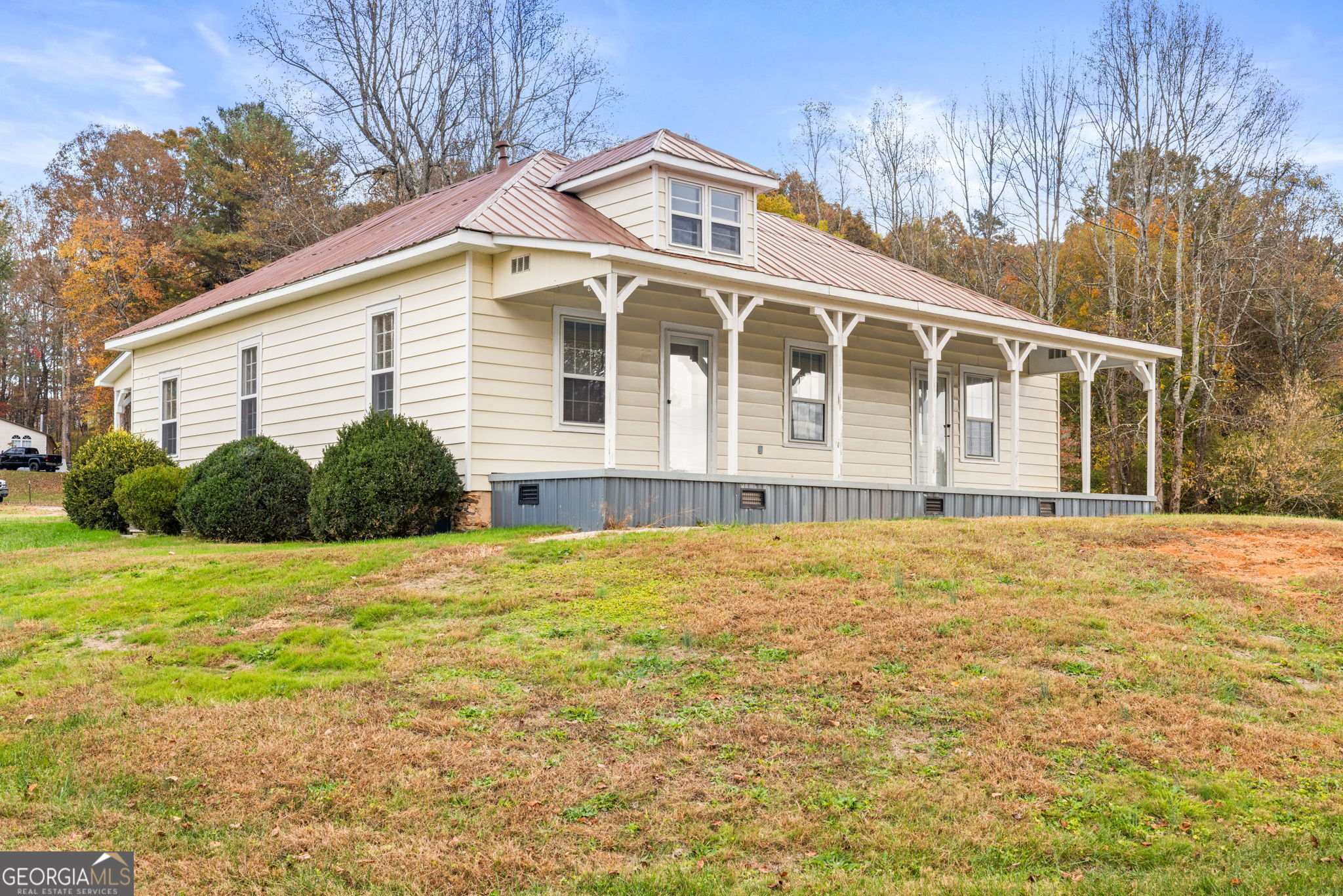 a front view of house with yard and trees around