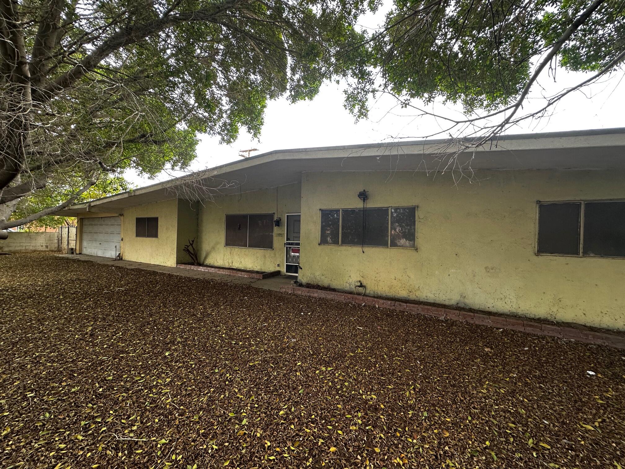 a house with trees in the background