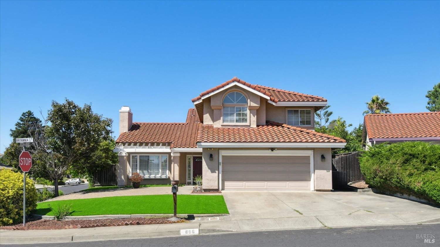 a front view of a house with a garden and yard