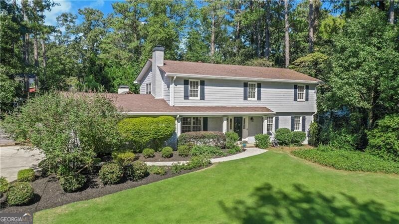 a front view of a house with garden