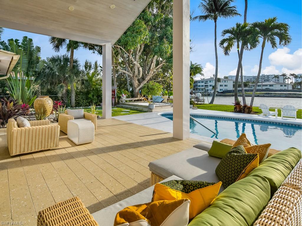 a view of swimming pool with outdoor seating