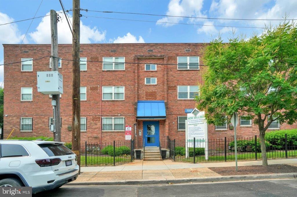 a view of a brick building next to a yard