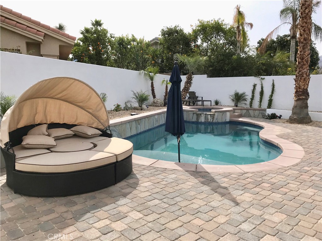 a view of a swimming pool with a patio