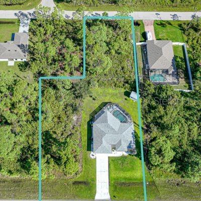 an aerial view of a house with a yard