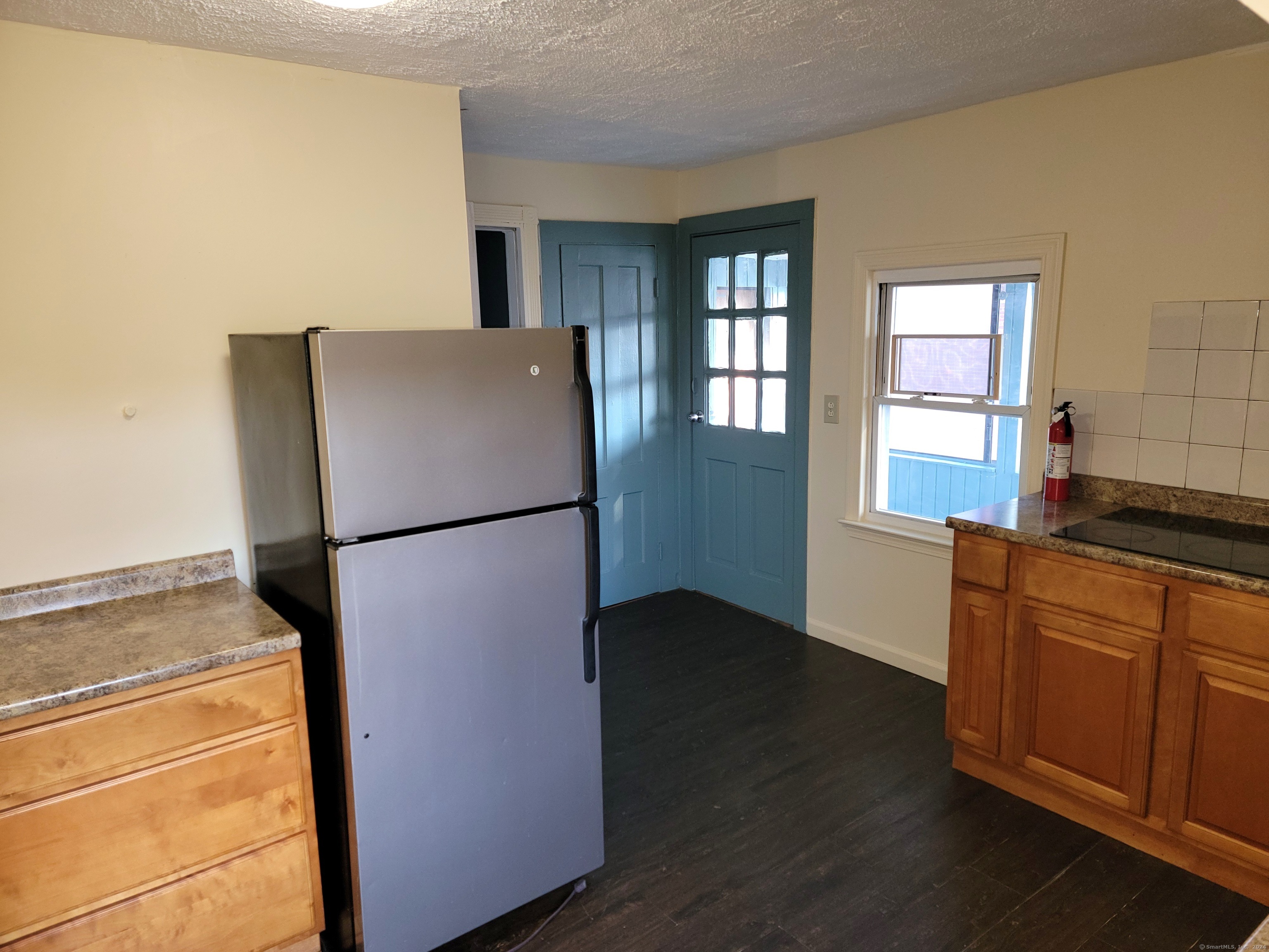 a kitchen with a refrigerator and a sink