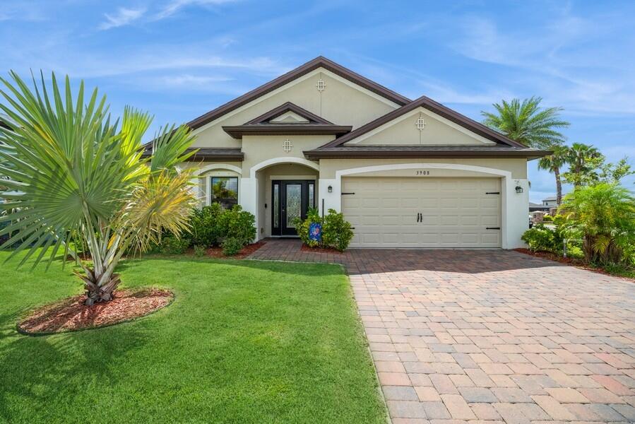 a front view of a house with a yard and garage