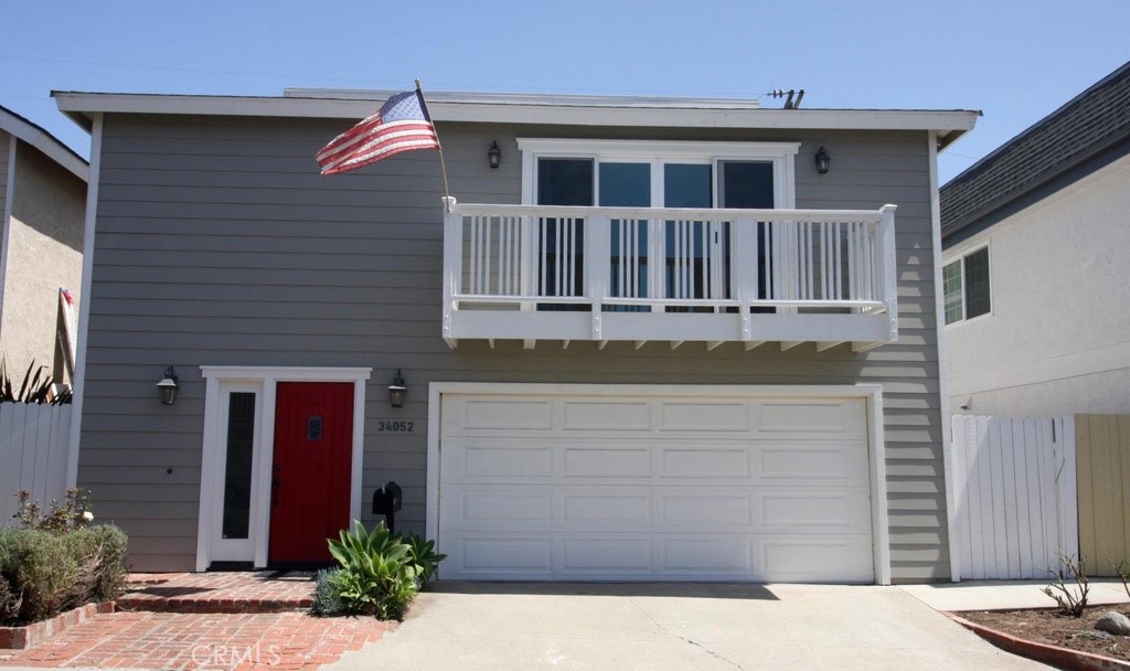 a front view of a house with plants