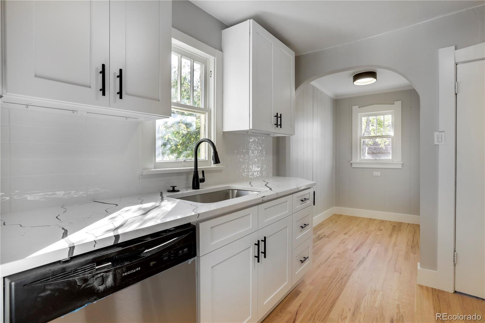 a kitchen with a sink stove and cabinets