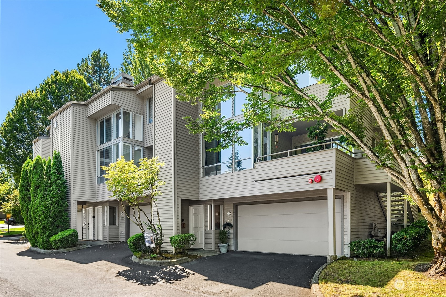 a front view of a house with a yard garage and outdoor seating