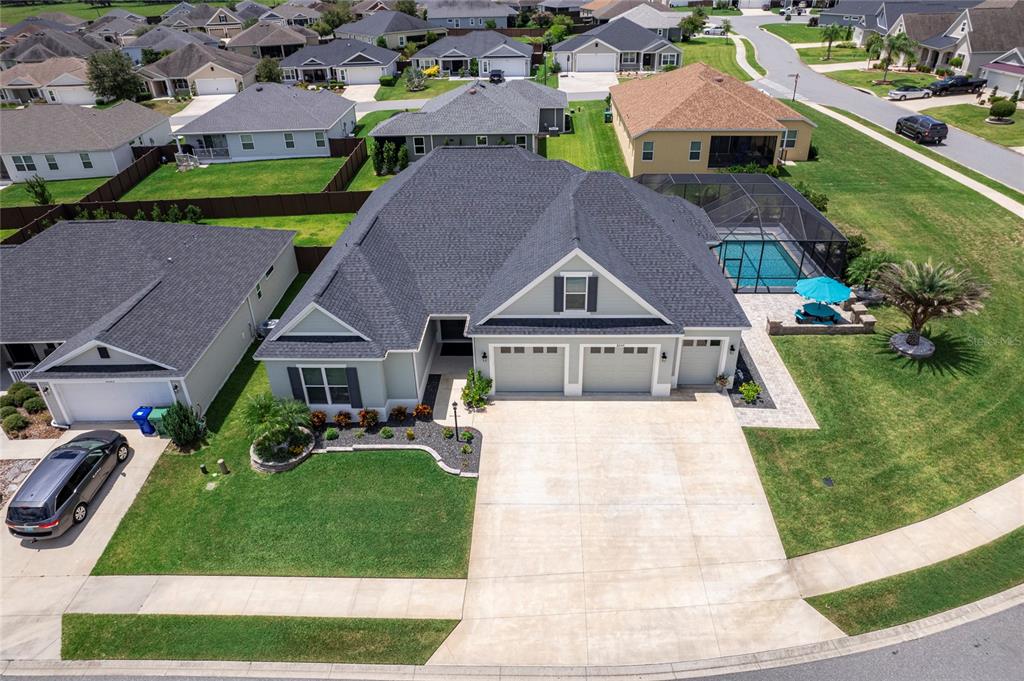 an aerial view of a house with a garden and trees