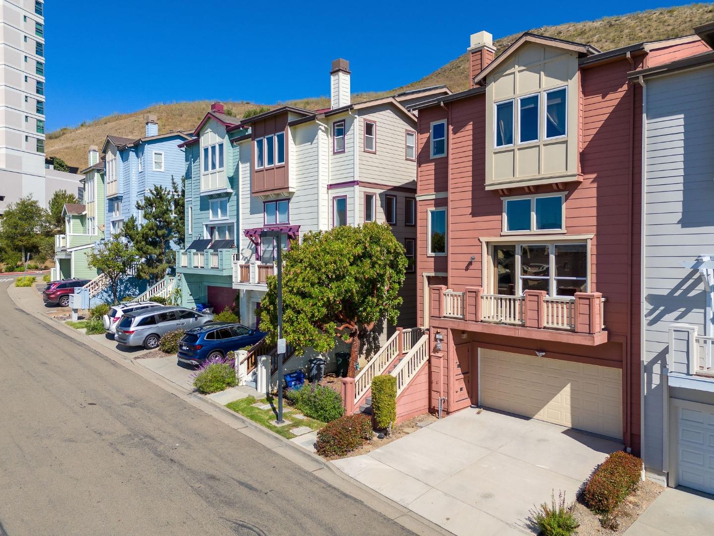 a front view of a multi story residential apartment building with yard