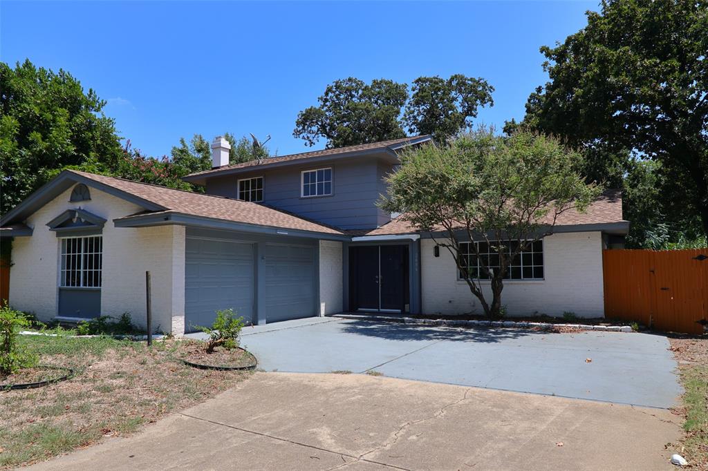 a front view of house with yard and trees