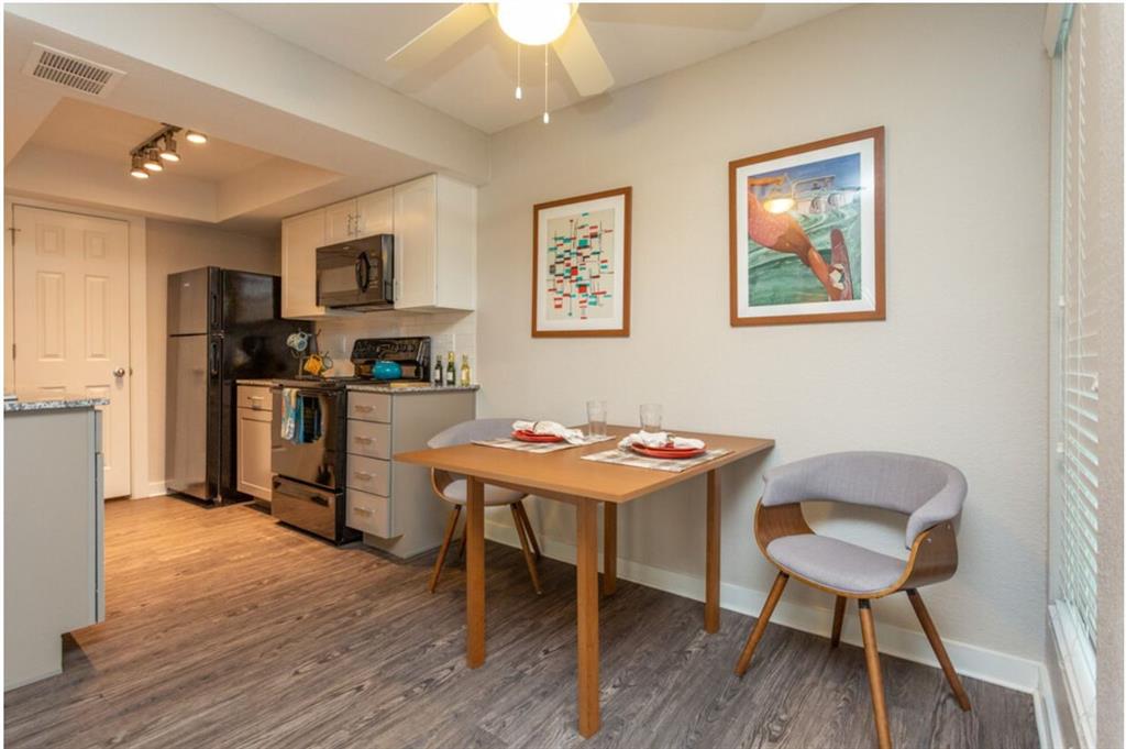 a view of a dining room with furniture and wooden floor