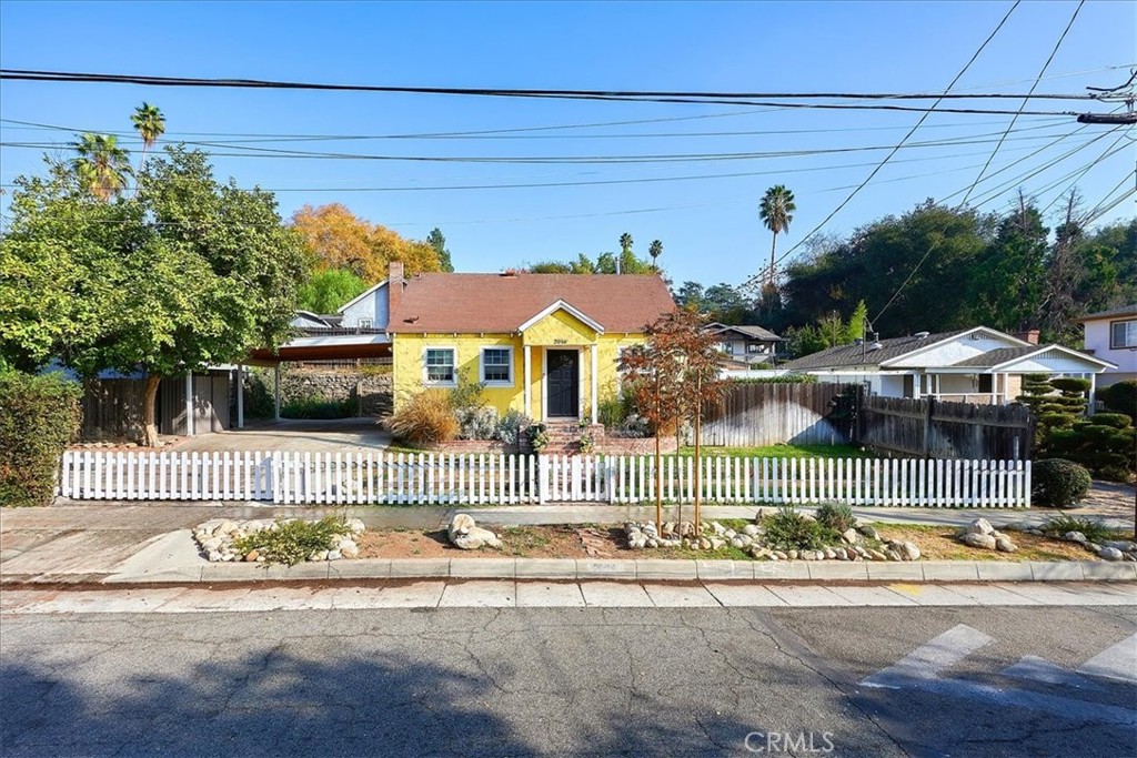 a front view of a house with a garden and plants