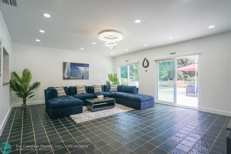 a living room with furniture and a glass door