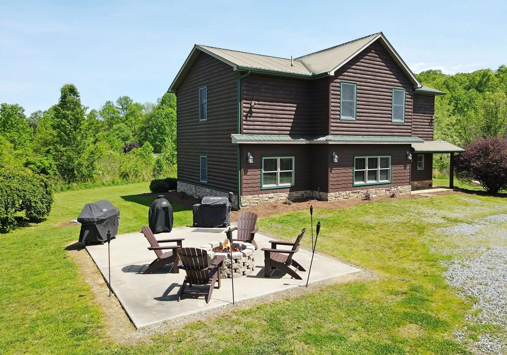 a view of a house with swimming pool and sitting area