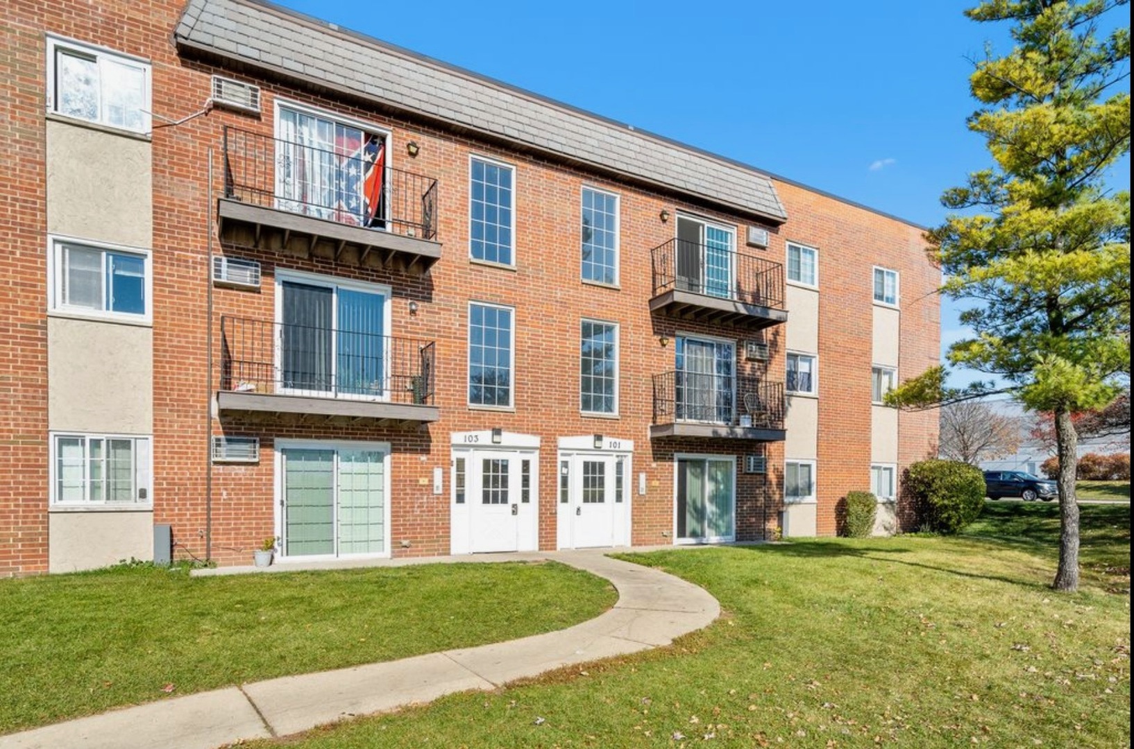 a view of a brick building next to a yard