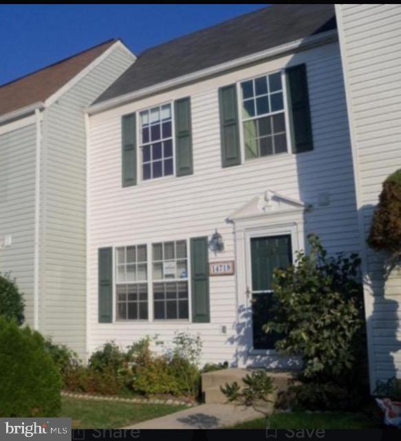 a view of a house with yard and garden