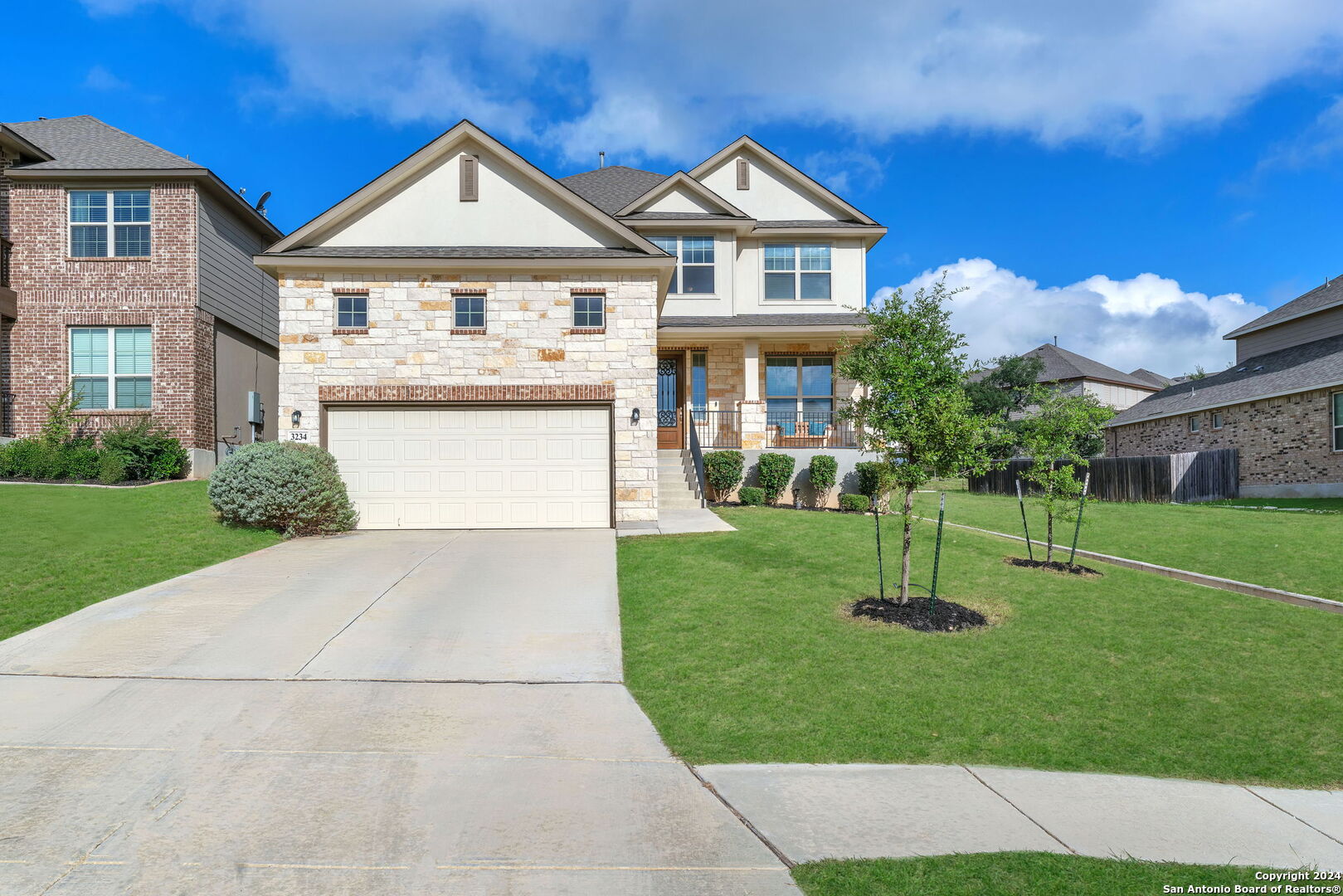 a front view of a house with a garden