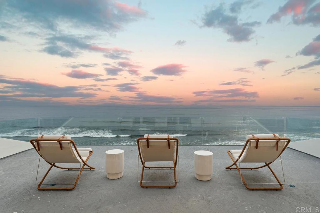 a view of a terrace with couple of chairs