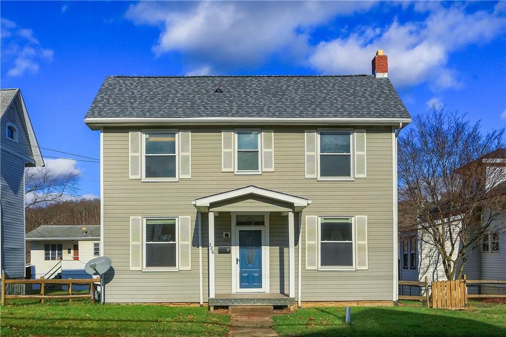 a front view of a house with a yard