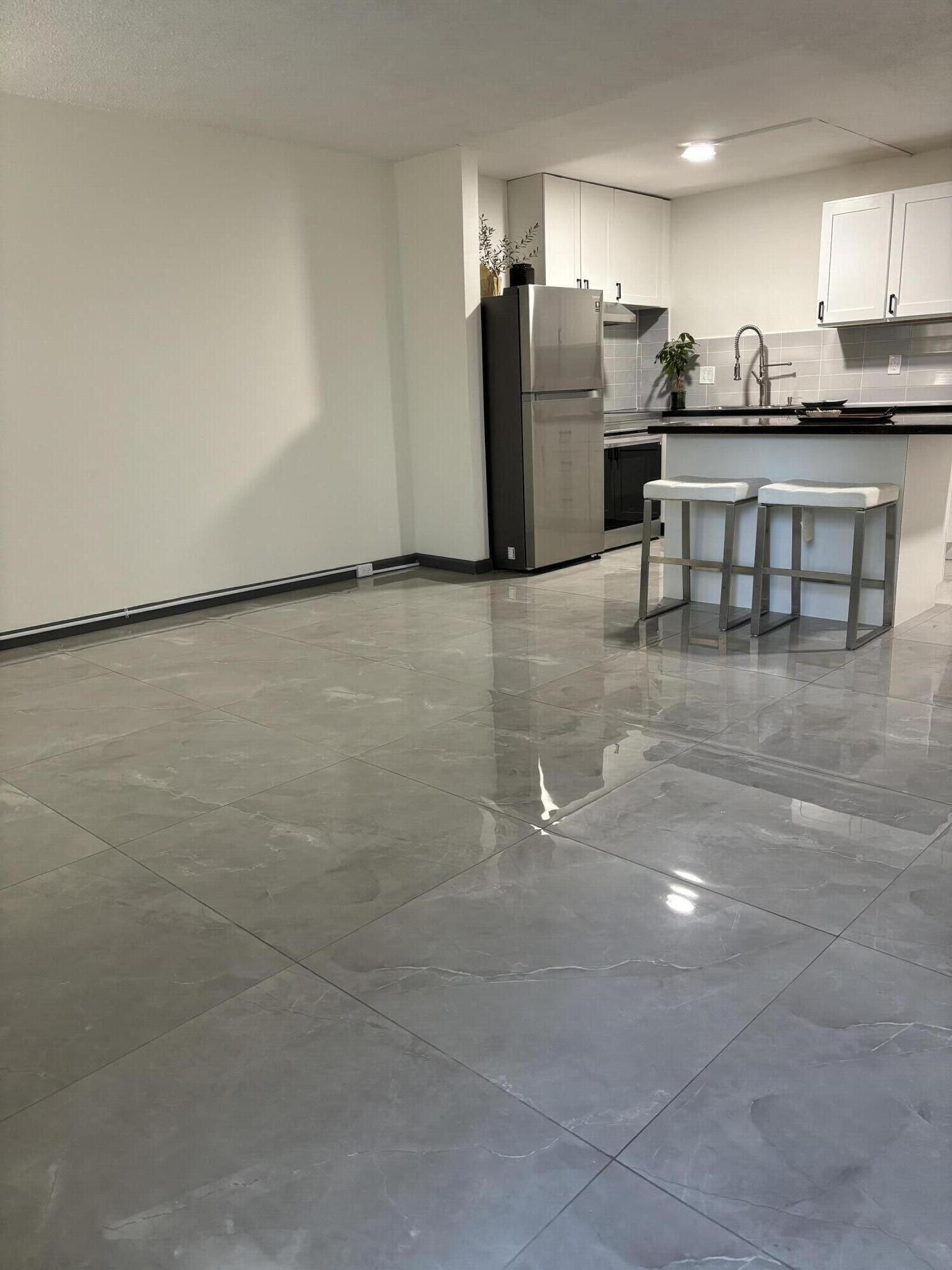 a kitchen with stainless steel appliances a refrigerator and a stove top oven