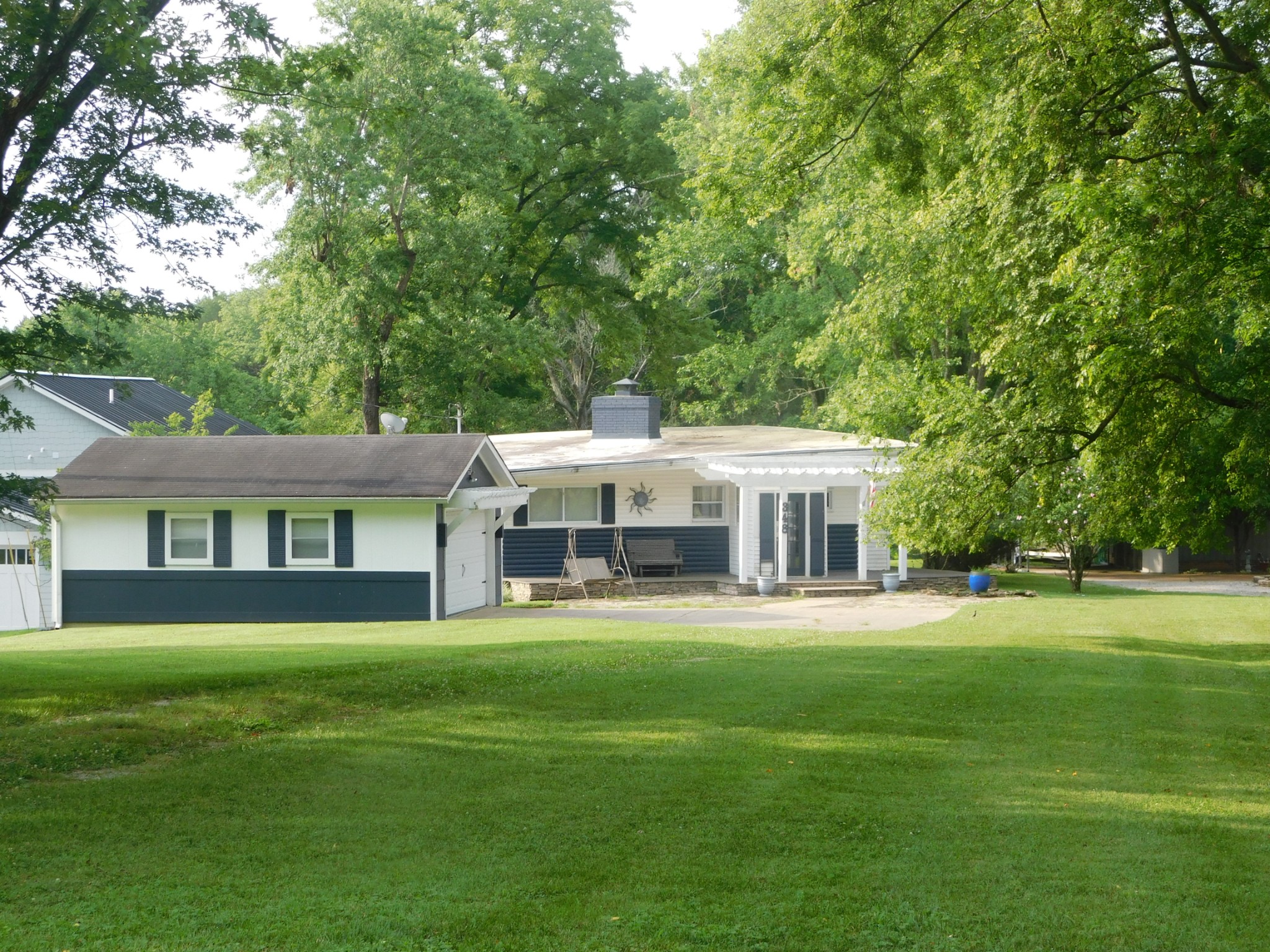 a front view of a house with a garden