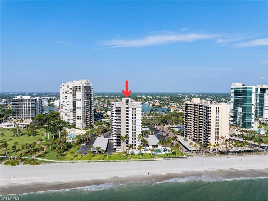 Birds eye view of property featuring a view of the beach and a water view