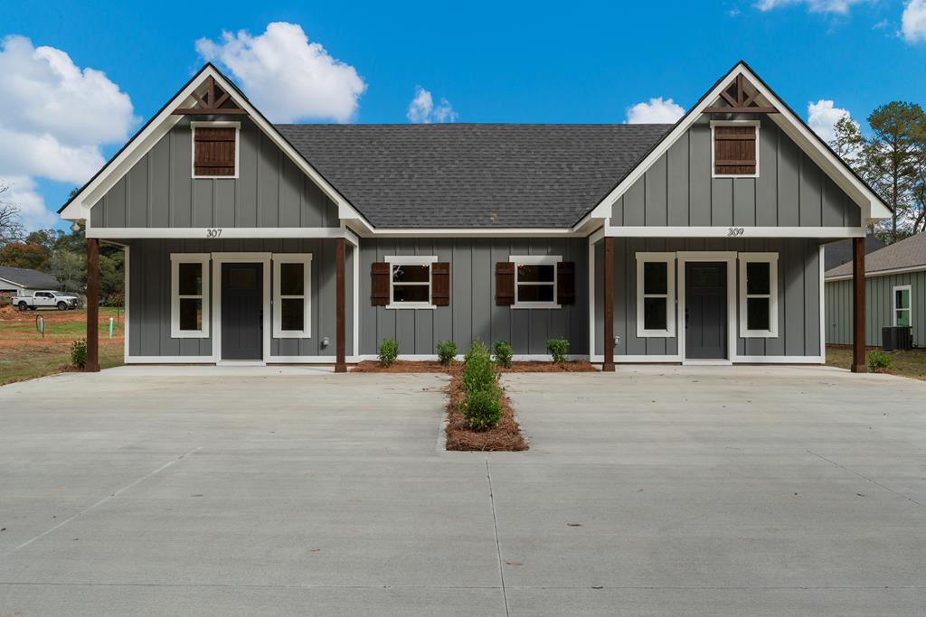 a front view of a house with a garden