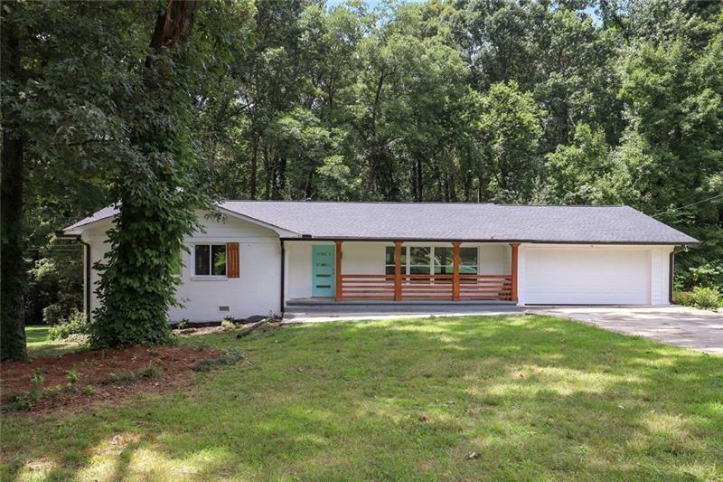 a house that has a big yard with large trees