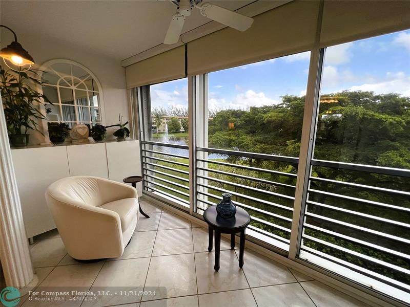 a view of sitting area with furniture and umbrella