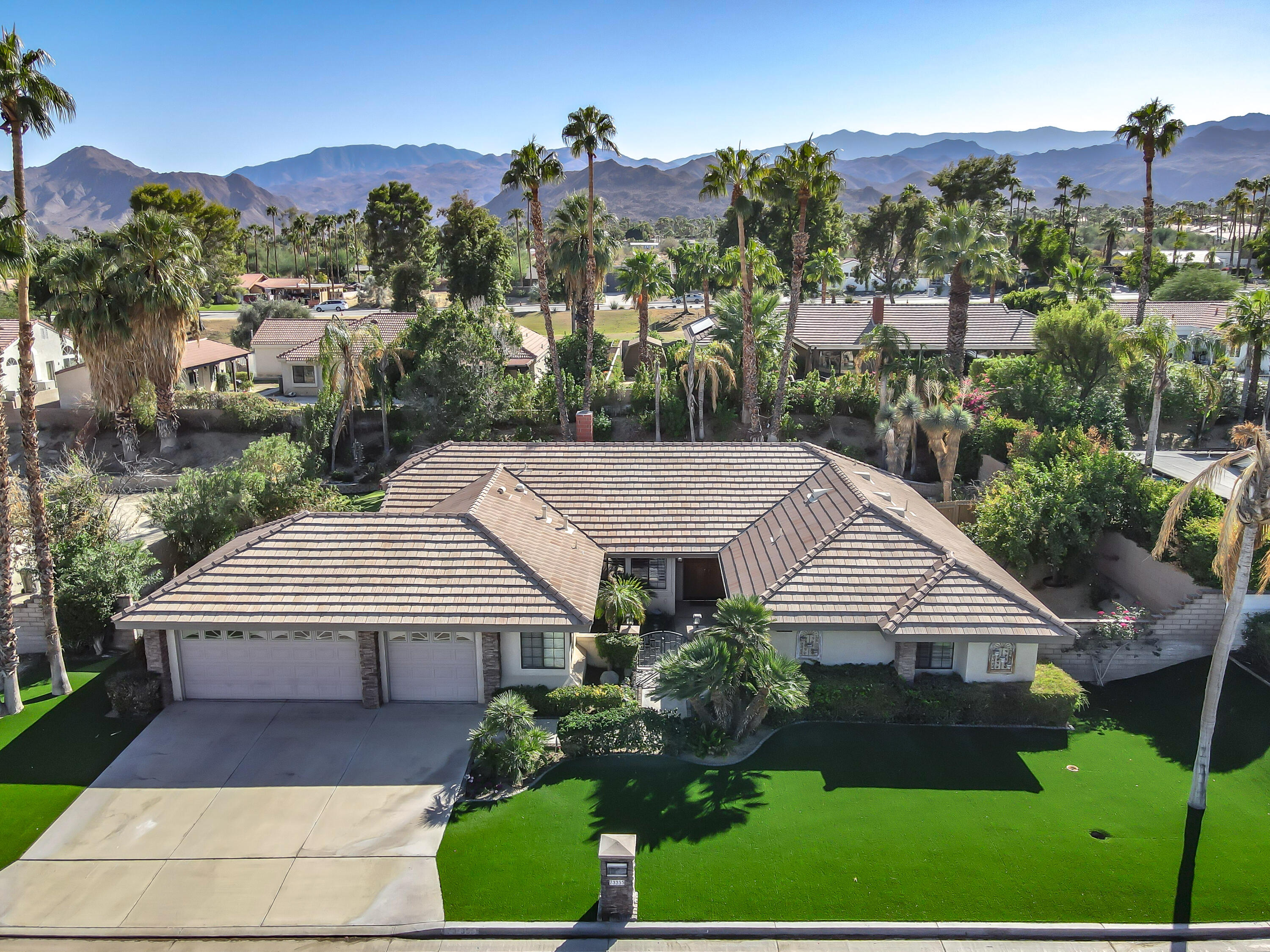 a aerial view of a house with a yard and potted plants