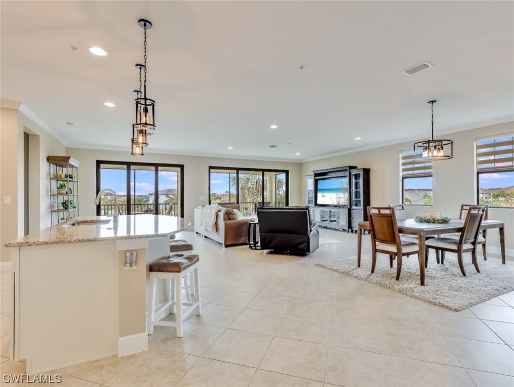 a living room with furniture a chandelier and a fireplace