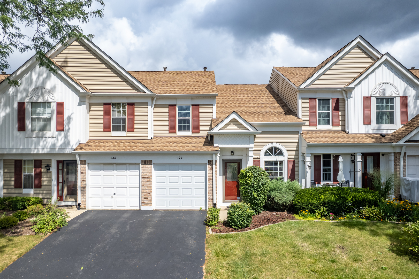 a front view of a house with a yard and garage